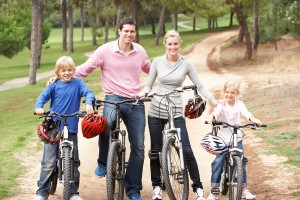 Family enjoying bike ride in park