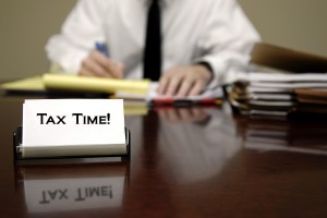 IRS tax auditor man sitting at desk with business card