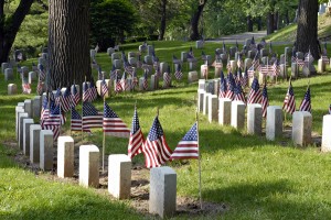 Memorials in Cemetery with American Flags