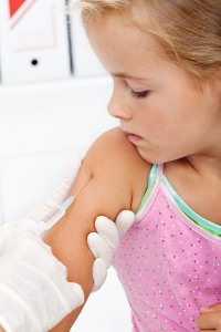 Little girl getting an injection or vaccine - closeup