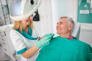 Female dentist strives to find closest color of dentures teeth