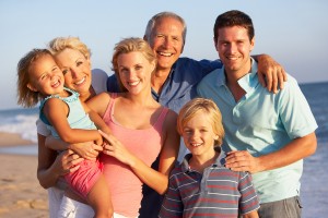 Portrait Of Three Generation Family On Beach Holiday